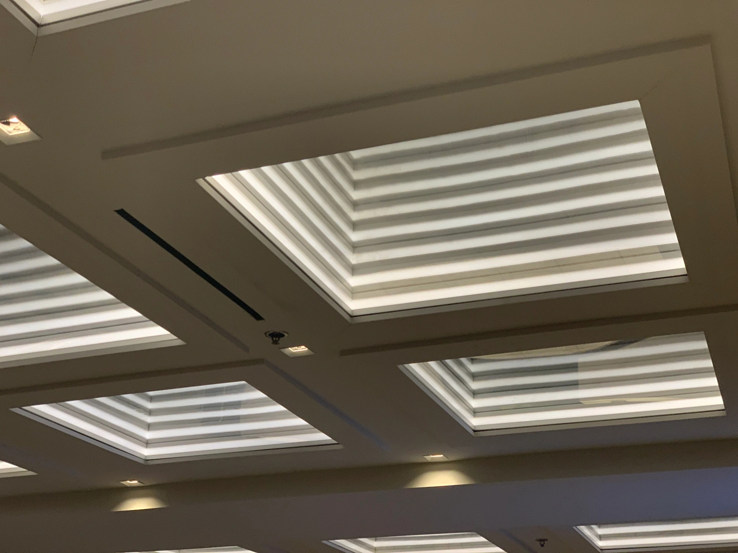 Ceiling lights that are large recessed squares covering the whole ceiling area
