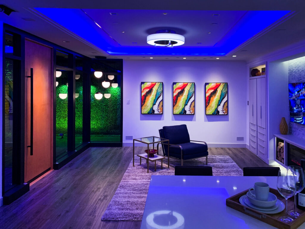 A room with various colors of light used to emphasize or harmonize different sections of the room