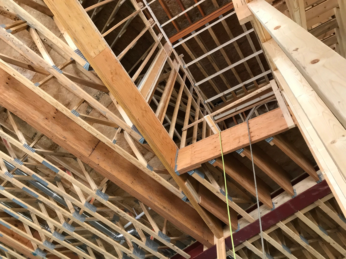 Looking up into the frame of a house under construction