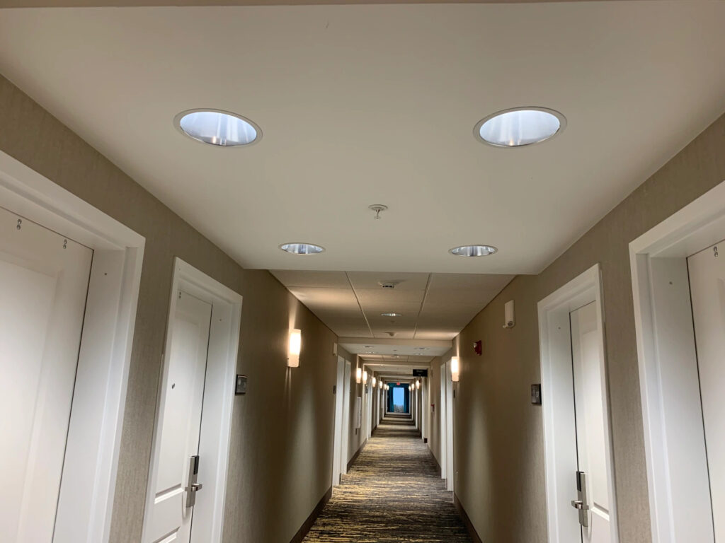 A long corridor of doors in a hotel