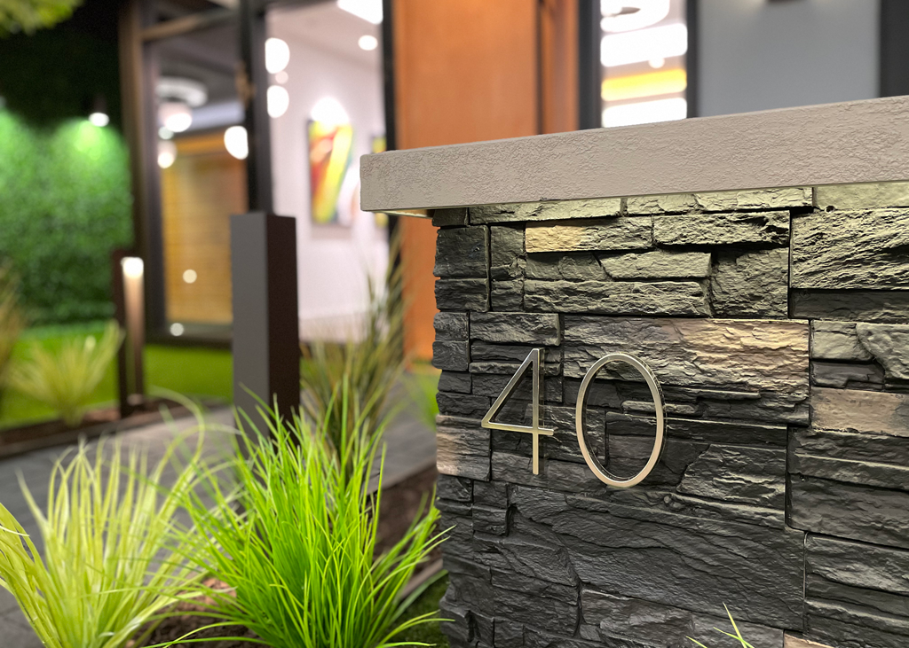 A photograph of the number 40 on a rock wall outside of a business.
