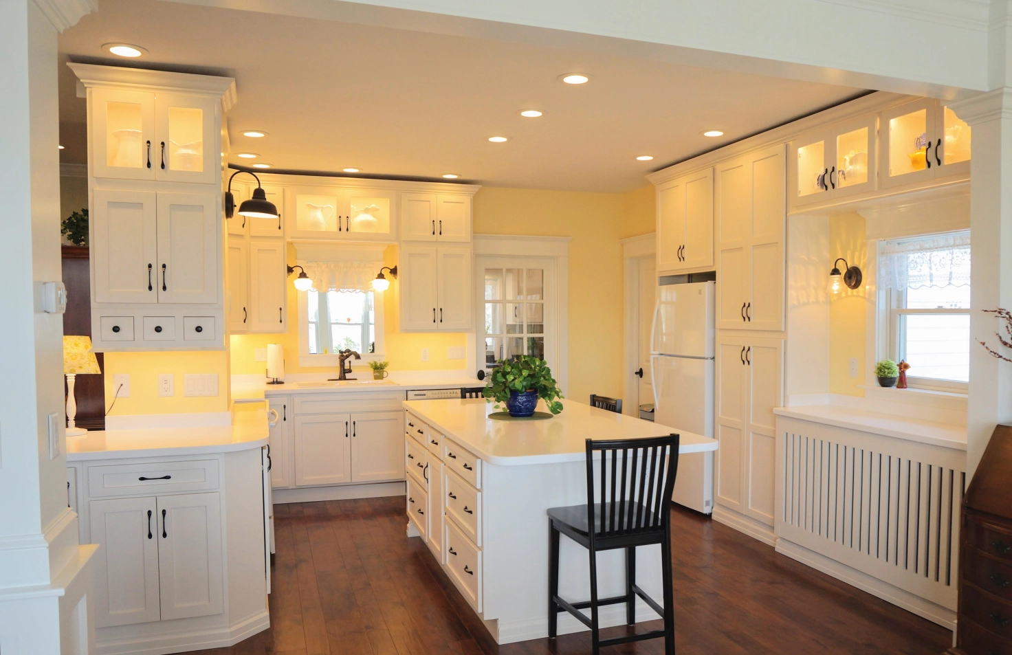 A very white kitchen with white cabinetry, white walls, white appliances, and a white ceiling.