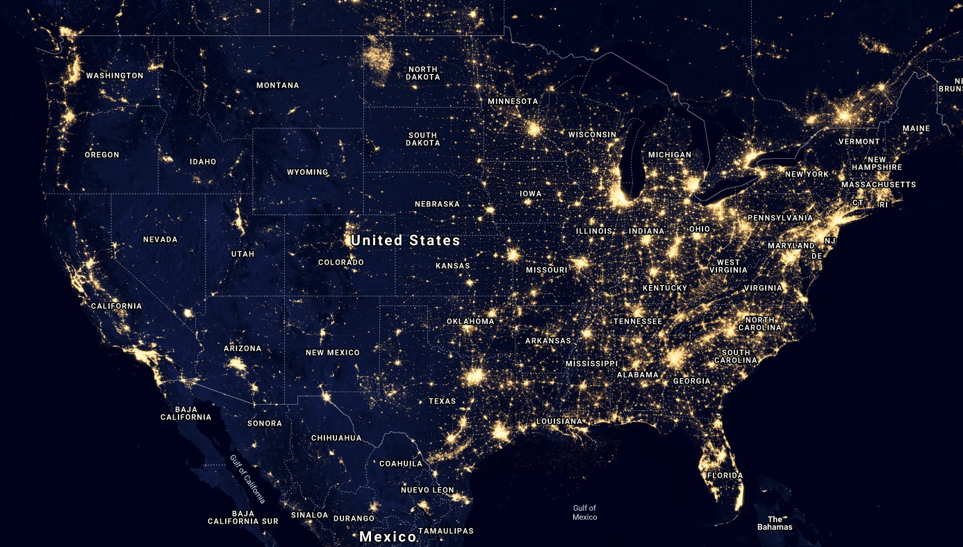 A satelite image of the contiguous United States taken at night. The city lights of metropolitan areas are lit up and visible from a very high altitude.