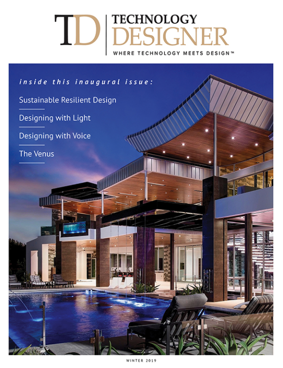 The cover of Technology Design magazine with an extravagant back deck of a large modern house complete with pool. Lit up at dusk.