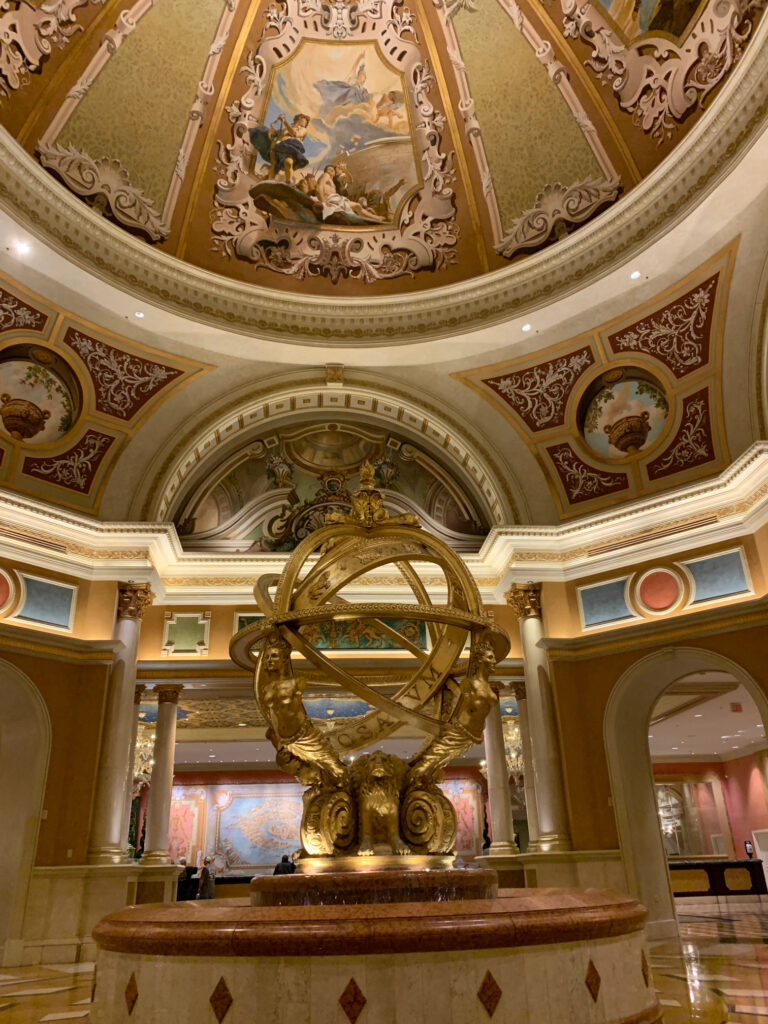 An opulent domed room with a golden statue in the center at the Venetian hotel in Las Vegas