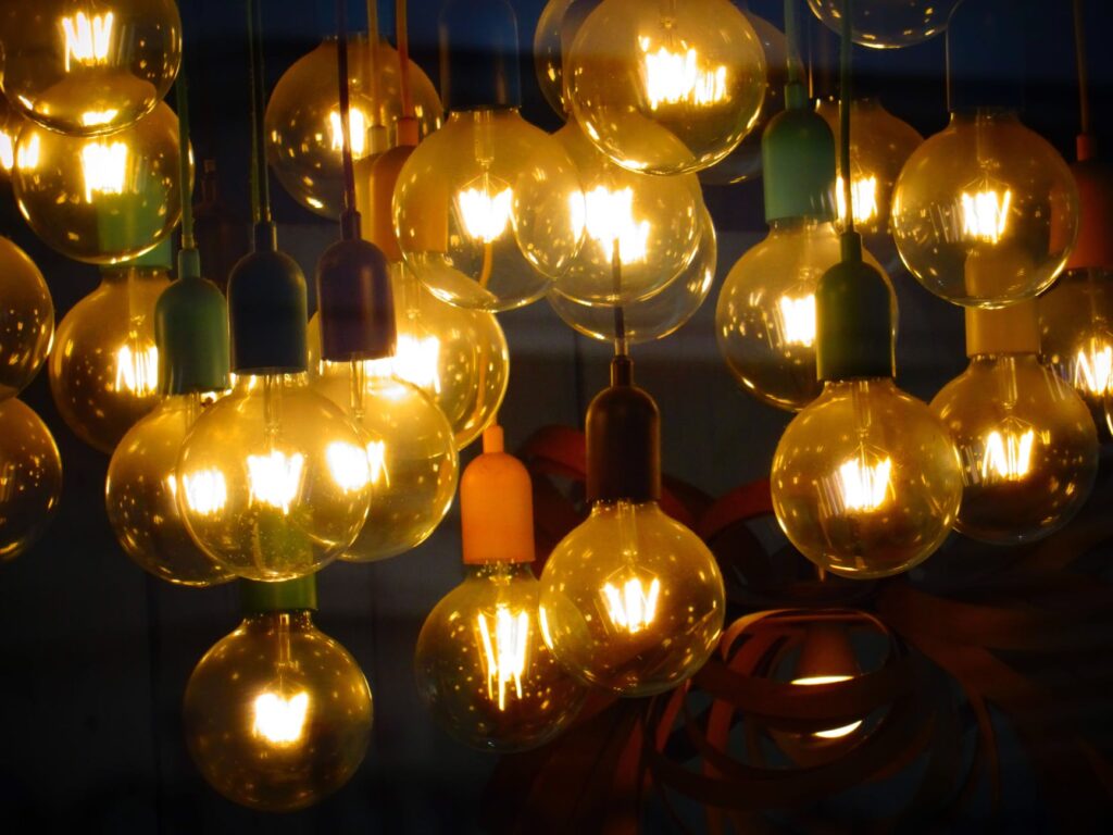 Many round lit light bulbs against a dark background